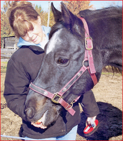 Kathryn gives Joshua an apple treat.
