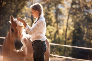Girl bonding with her horse