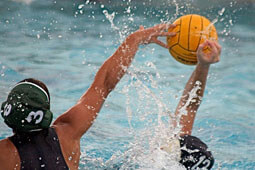 Kawahinealoha (no. 3) blocking a shot for the Orange County College Pirates.